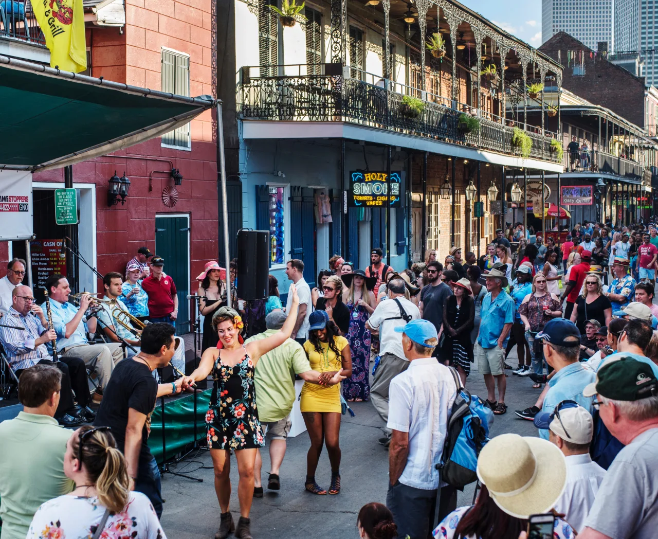 A couple dancing to a brass band on a crowded French Quarter street