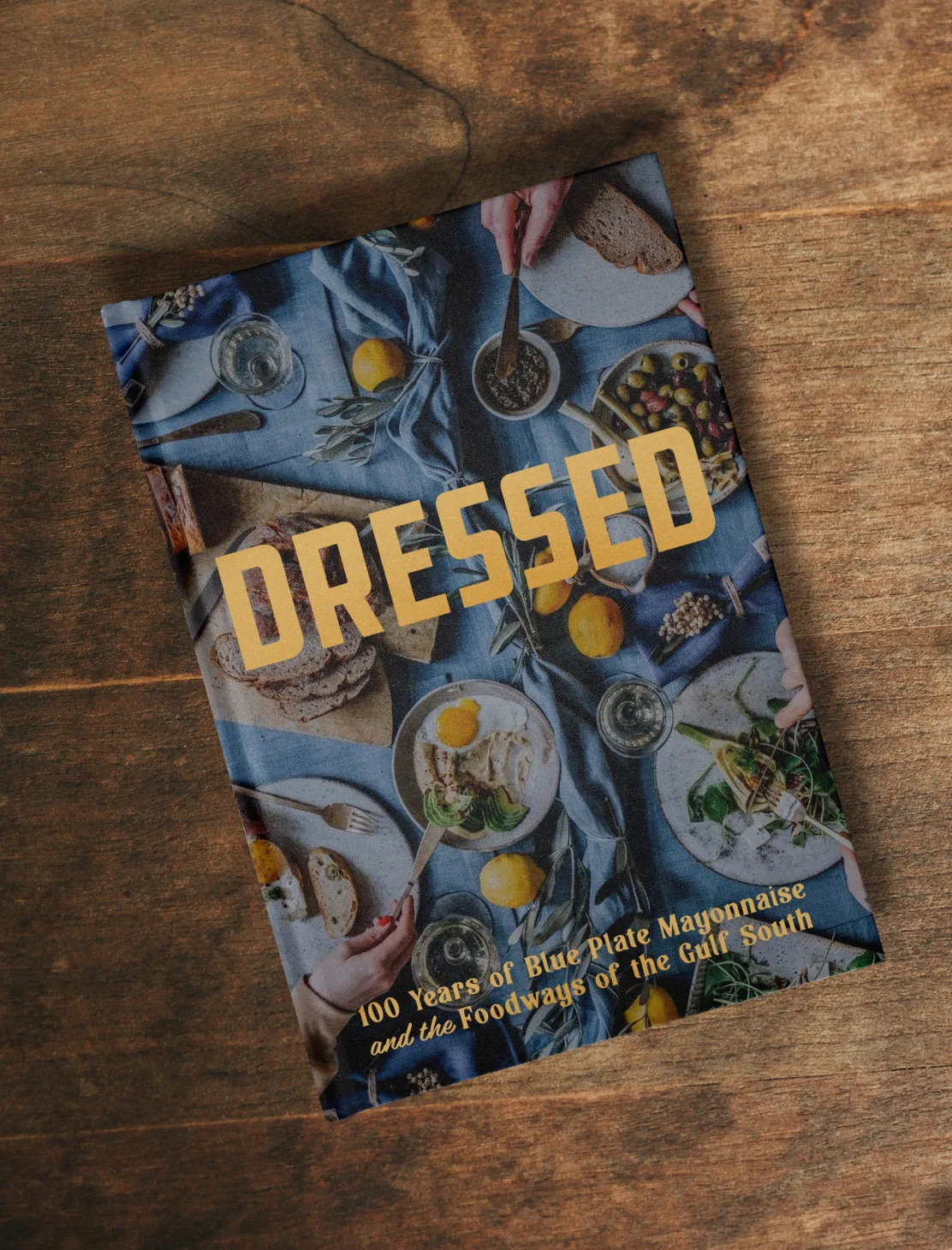 The Dressed cookbook on a wooden table